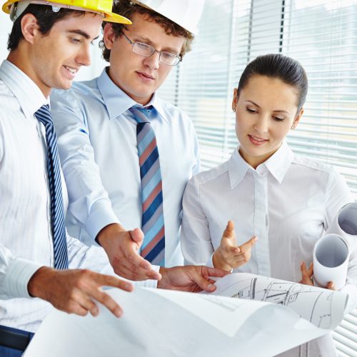 Three architects discussing sketch of new project